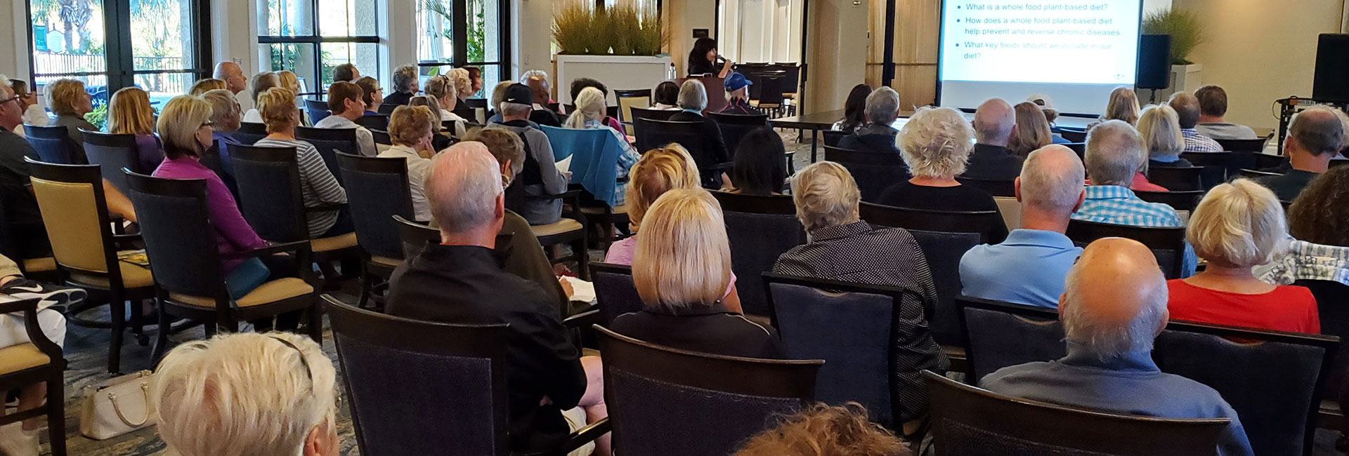 Speaker giving a presentation to a room full of people