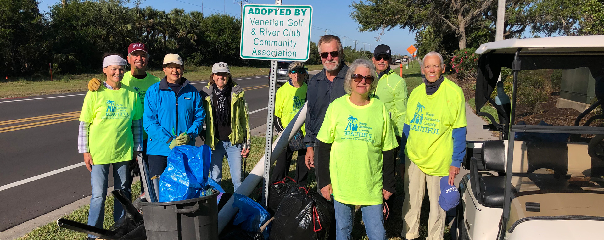 A group of volunteers cleaning a roadway